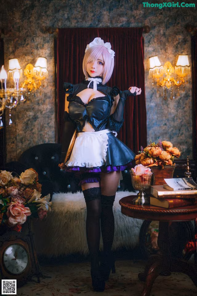 A woman dressed in a maid outfit posing for a picture.