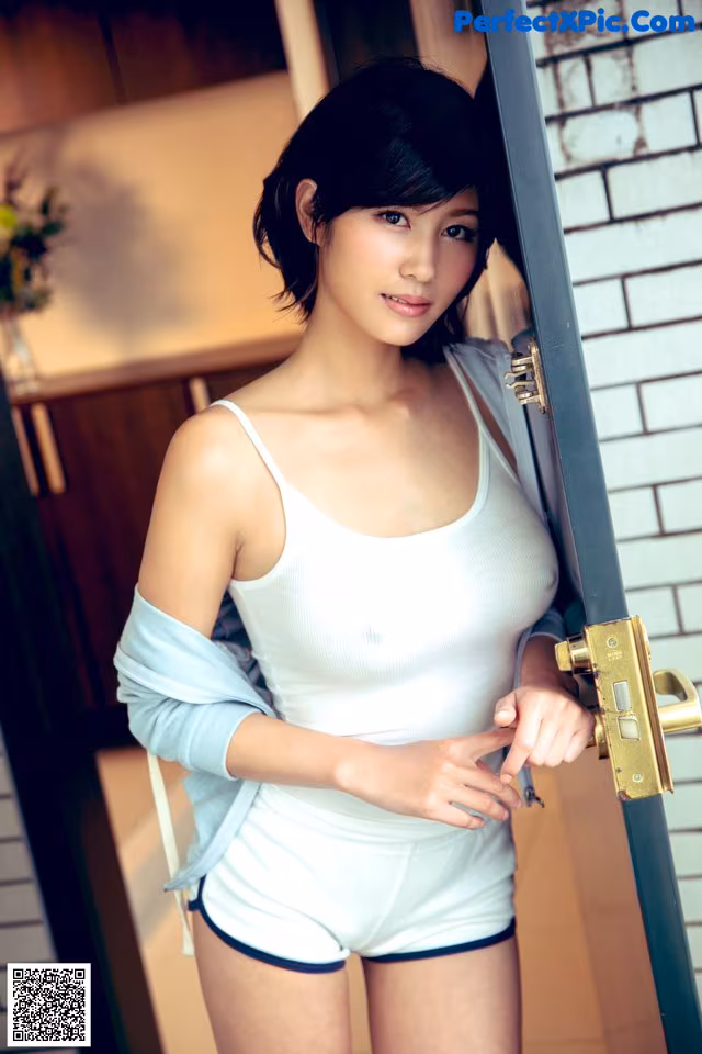 A woman standing in front of a door with a lock.