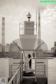 A naked woman standing on top of a metal structure.