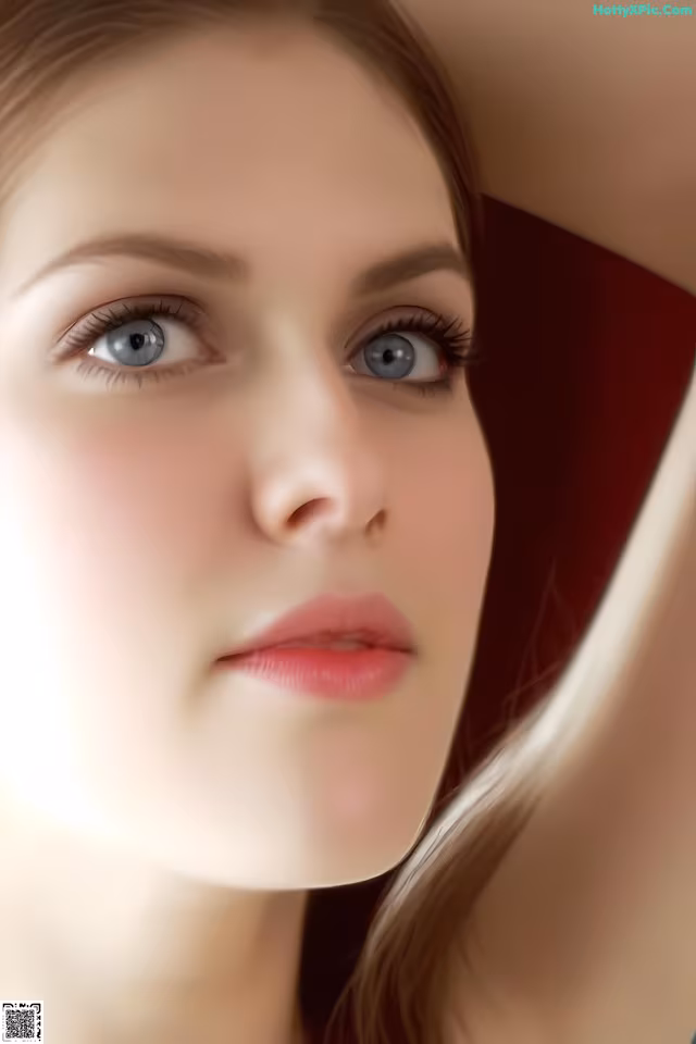 A close up of a woman's face with blue eyes.