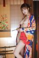 A woman in a kimono is posing for the camera.