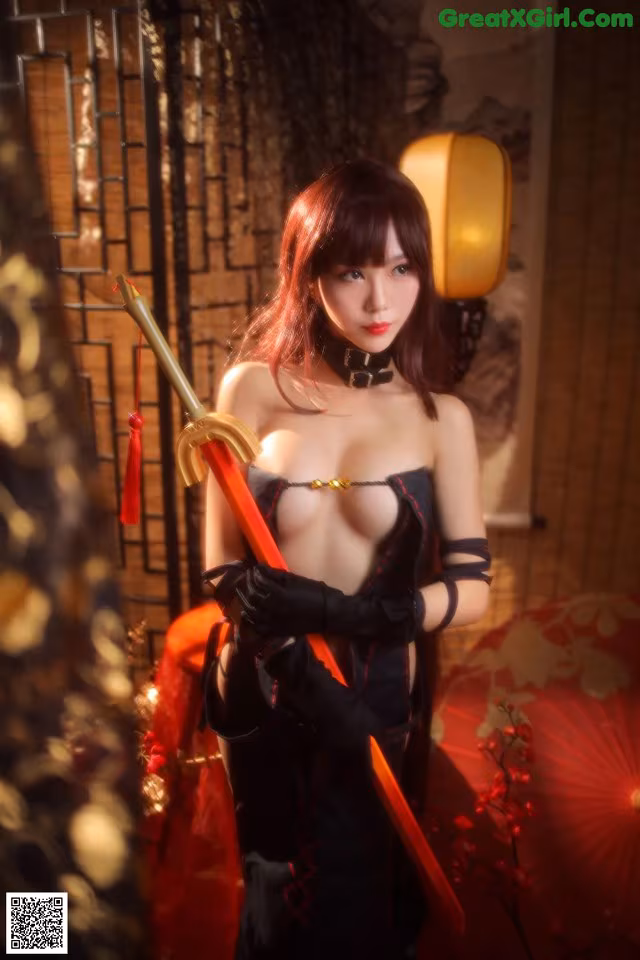 A woman in a black dress holding a sword.