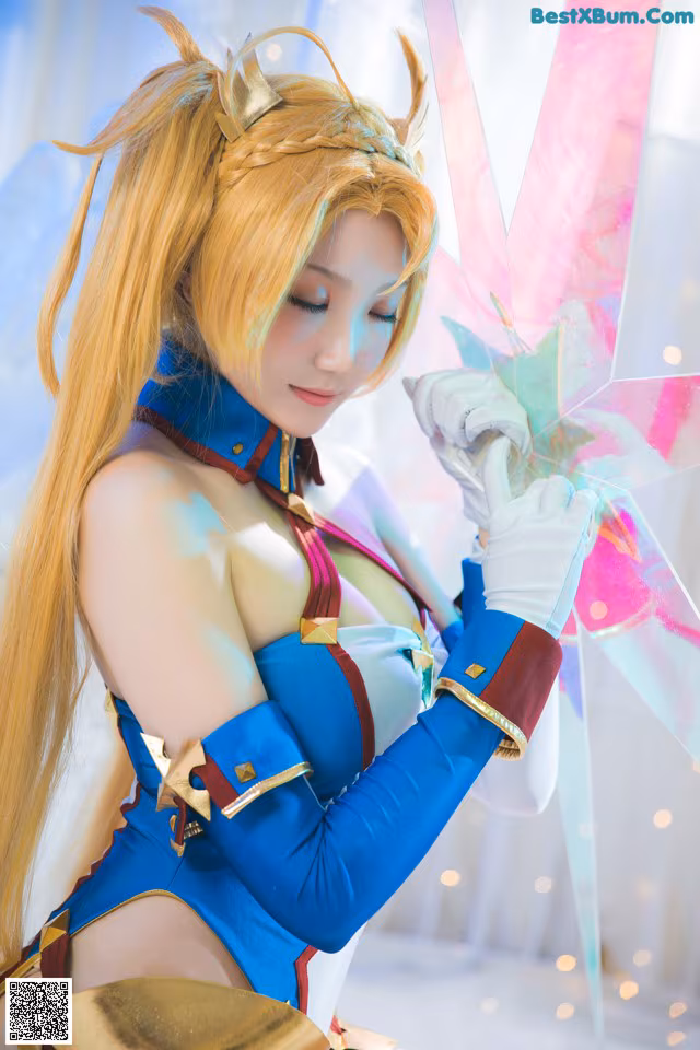 A woman in a blue and gold outfit holding a sword.