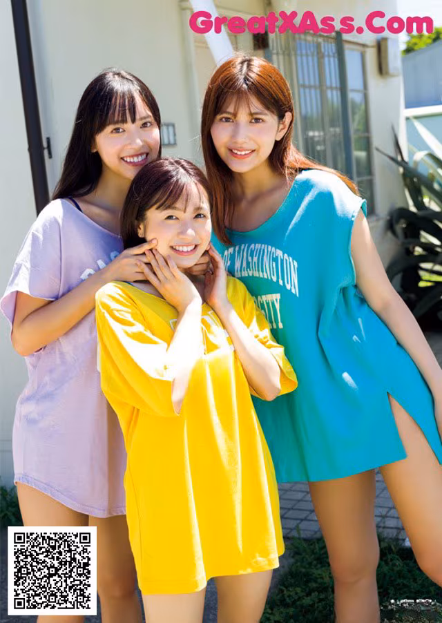 A group of three young women standing next to each other.
