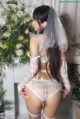 A woman wearing a white lingerie and a veil.