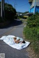 A person laying on a blanket with a teddy bear.