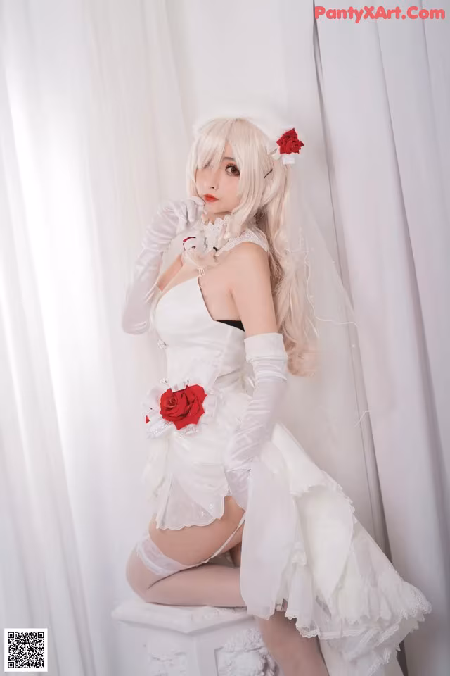A woman in a wedding dress sitting on a stool.