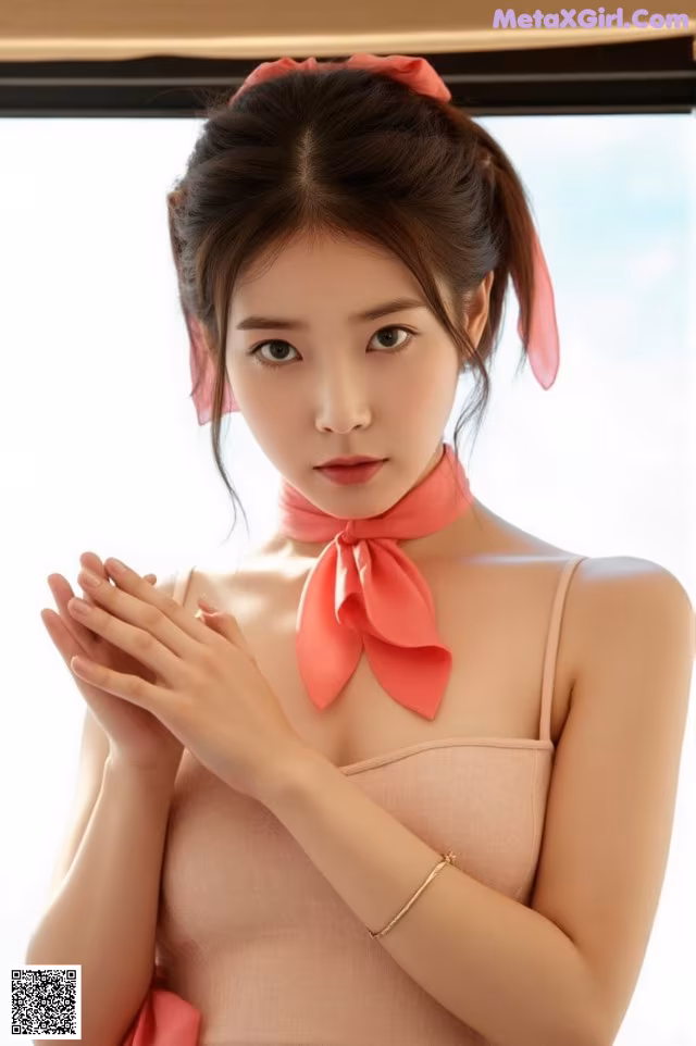 A woman in a pink dress with a pink bow on her neck.
